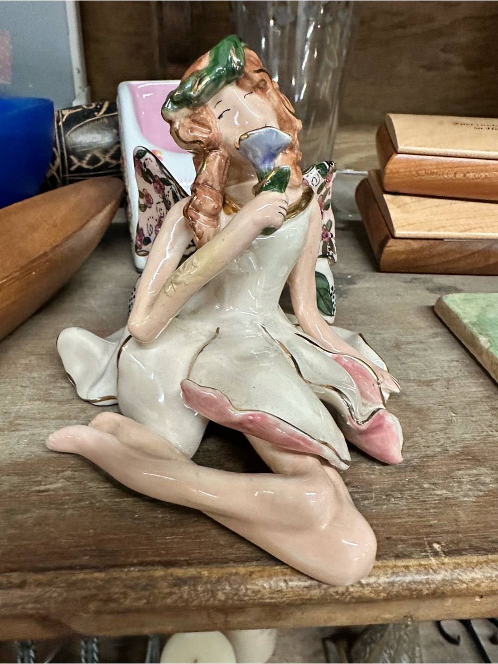 This is a Blue Sky figurine of a seated angel designed by Heather Goldminc